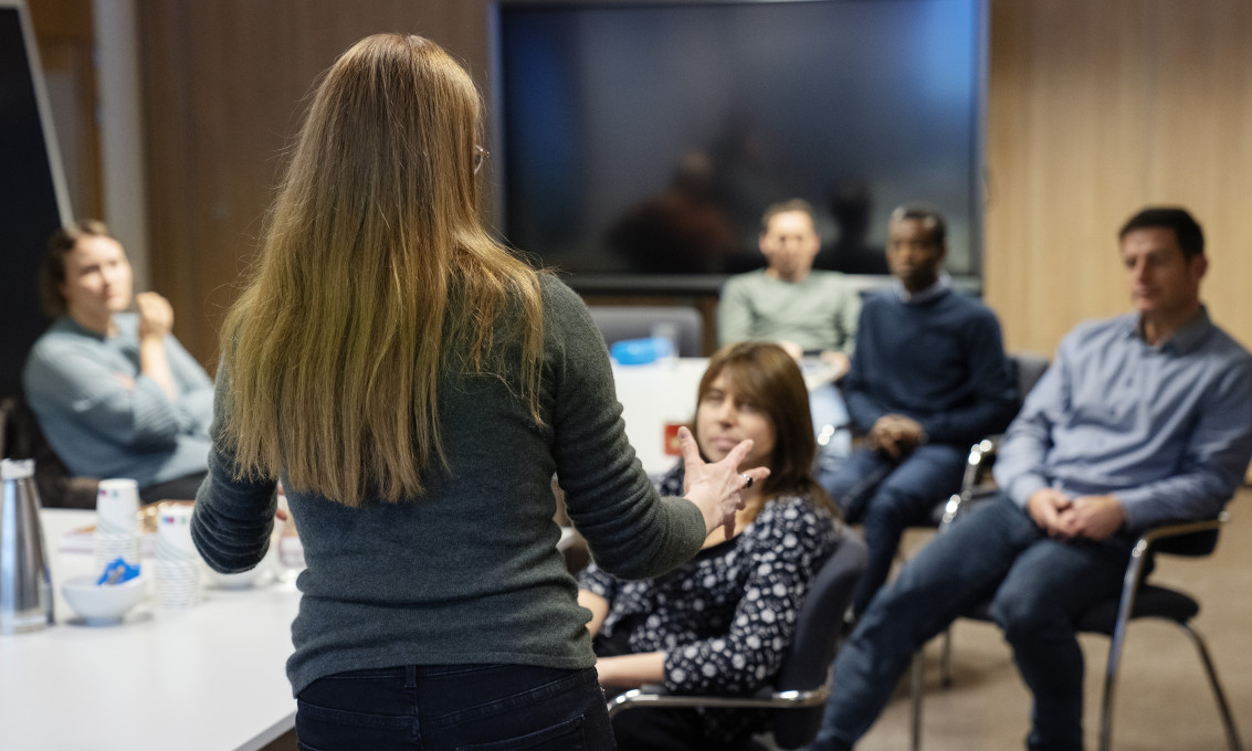Woman talking in front of a group of people