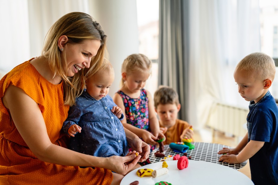 Voksen leker med barn i barnehage