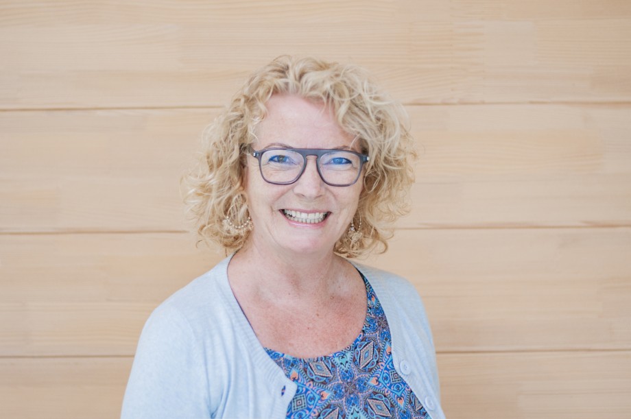 Smiling woman with glasses.